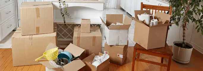 Packed moving boxes and household items in a kitchen before move-out or move-in cleaning, Lincoln, NE.